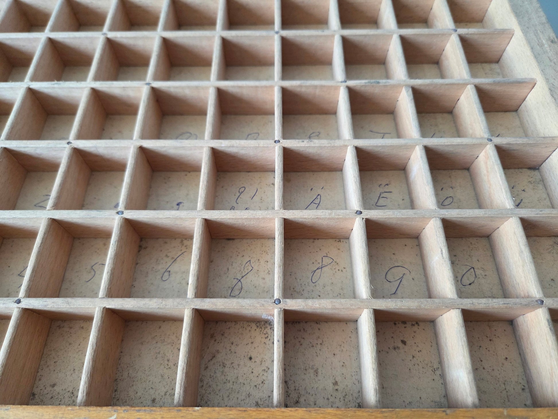 houten letterbak met potloodschrift in vakjes